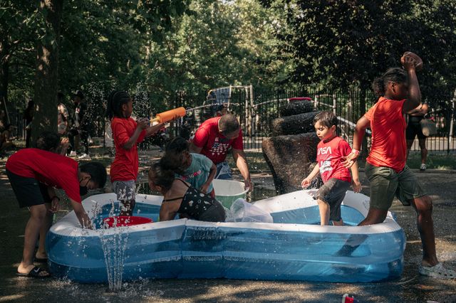Children play with water guns and an inflatable pool in Brower Park, Crown Heights, on Friday July 22nd.